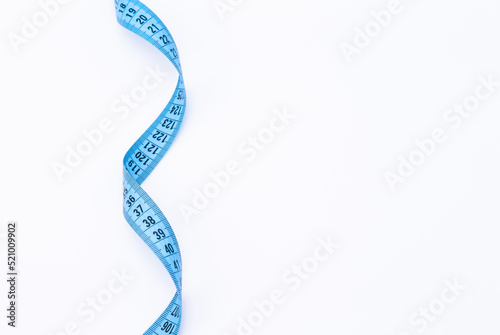 The photo shows a blue tape measure isolated on white background
