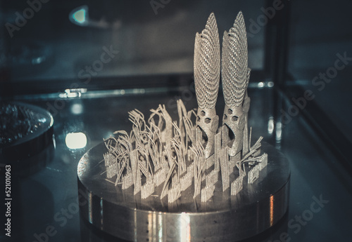 Object printed on metal 3d printer close-up. Object printed in laser sintering machine. Modern 3D printer printing from metal powder. Concept progressive additive DMLS, SLM, SLS 3d printing technology photo