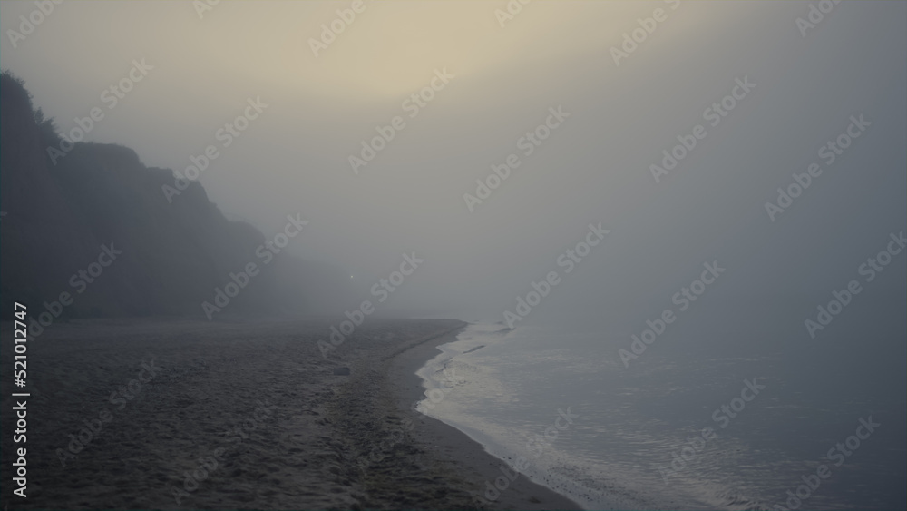 Scenic view rocky beach in morning fog. Sea landscape at sunrise