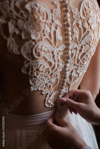 Wearing of wedding dress. Elegant Lace and buttons. Beautiful Wedding Dress Design. 