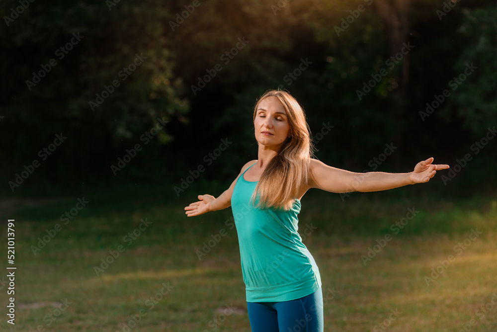 Portrait of young fit woman with closed eyes meditating outdoor at summer day Portrait of young fit woman with closed eyes meditating outdoor at summer day