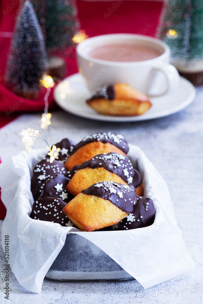 Traditional French madeleine cookies served with coffee, Christmas decor.