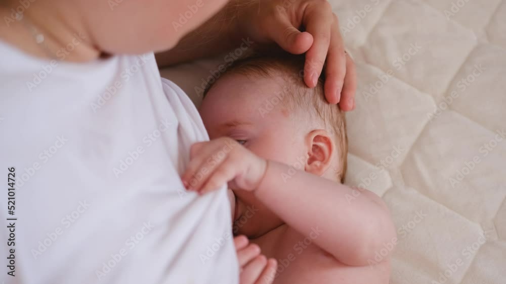 mother breastfeeding baby at home mom nursing infant nurturing child suckling milk from breast motherhood maternity care mother breastfeeding baby at home mom nursing infant nurturing child suckling milk from breast motherhood maternity care