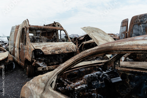 Burned civilian car. Stacked vehicles. War in Ukraine.