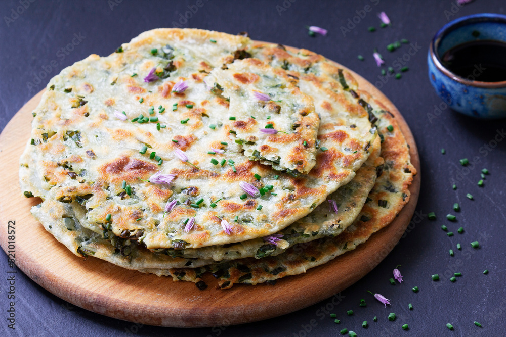 Homemade appetizing scallion pancakes served with soy sauce.