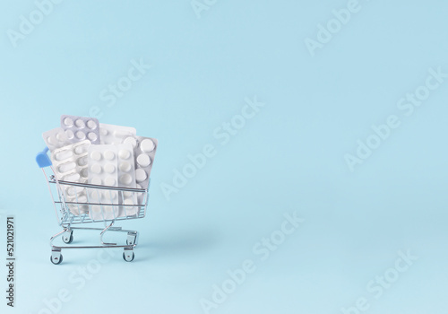 Blisters with pills in a shopping cart trolley.