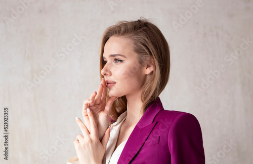 portrait of a young girl with long blonde hair in a purple suit