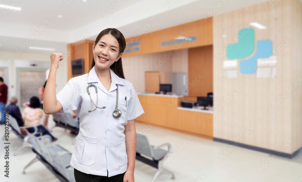 Asian female doctor wearing white medical uniform with short sleeves Hang the heart rate monitor on your neck. showing joy and encouragement happy smile in the background is a hospital Asian female doctor wearing white medical uniform with short sleeves Hang the heart rate monitor on your neck. showing joy and encouragement happy smile in the background is a hospital