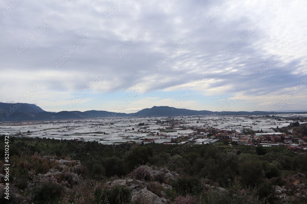 view from Ruins of Xanthos on Xanthos with lots of greenhouses, Turkey