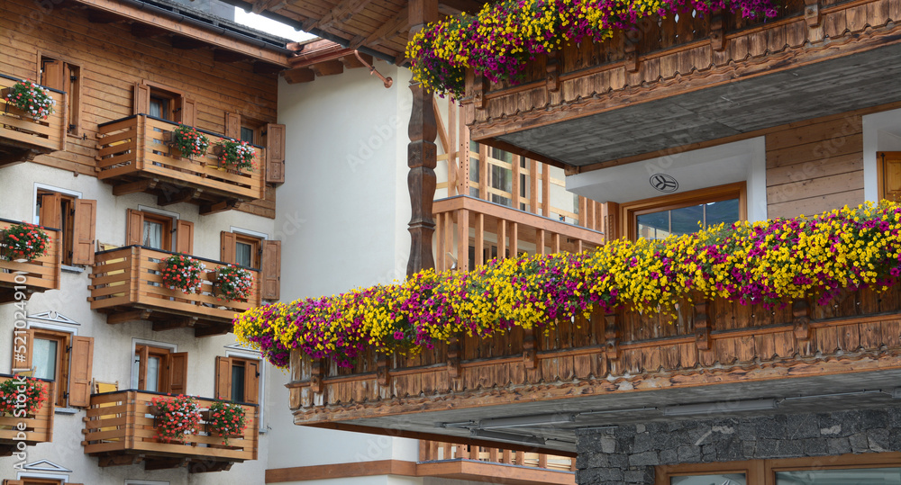 the flowery mountain houses of the mountain village have spectacular vases of geramiums with beautiful and brilliant colors.