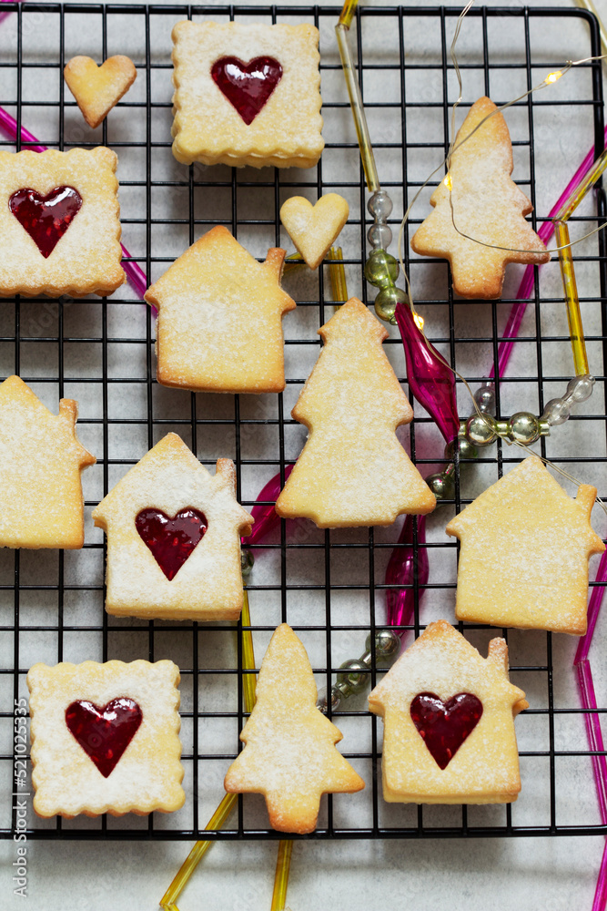 Sugar cookies stuffed with raspberry jam on a light background. Christmas and New Year's decor.
