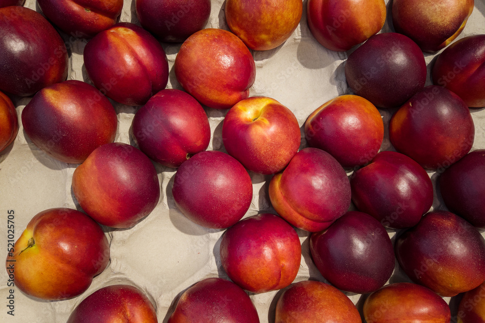 Nectarines in cassette for sale, top view of peaches Necatrines ripe Nectarines in cassette for sale, top view of peaches Necatrines ripe