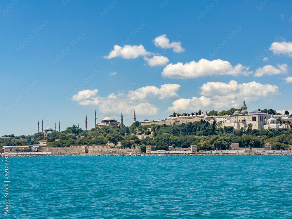 Historical view on Istanbul city on a sunny day with Ottoman Topkapi museum, Hagia Spohia church and Blue Mosque in background. Beautiful travel destination postcard, poster banner