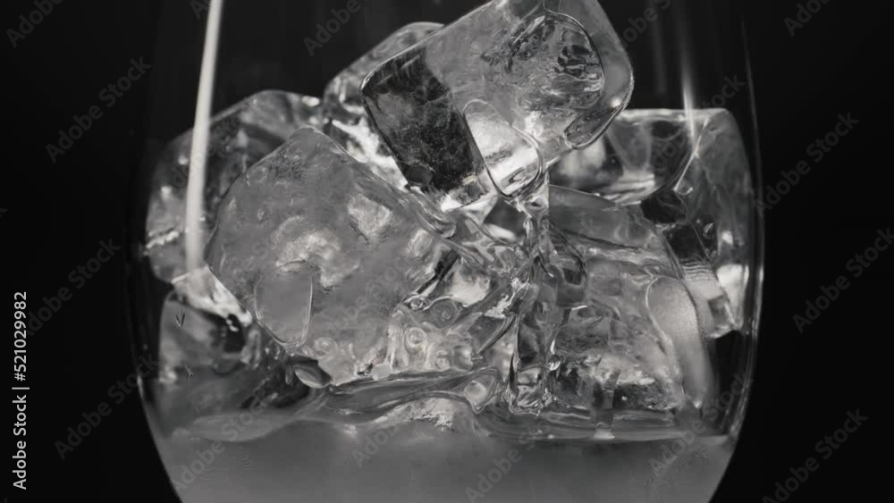 Ice cubes melting glass closeup. Cold beverages and cocktails concept Ice cubes melting glass closeup. Cold beverages and cocktails concept