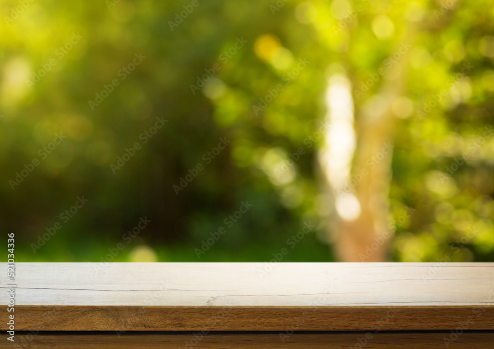 Art Empty wooden deck table on sunny green garden background Art Empty wooden deck table on sunny green garden background