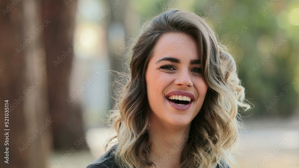 Hispanic latin girl looking to camera laughing outdoors Hispanic latin girl looking to camera laughing outdoors