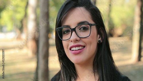 happy woman wearing glasses looking to camera with smiling