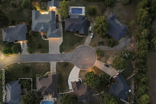 Aerial overhead view of a cul-de-sac in a suburban residential neighborhood at sunset