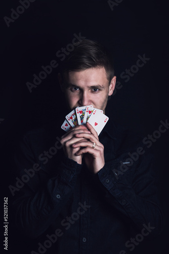 Принти на полотні Successful poker player holds up a winning royal flush combination