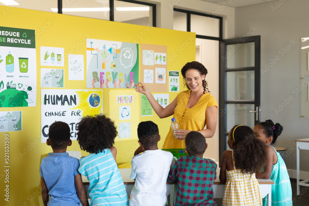 Caucasian female teacher teaching environmental conservation to african ...
