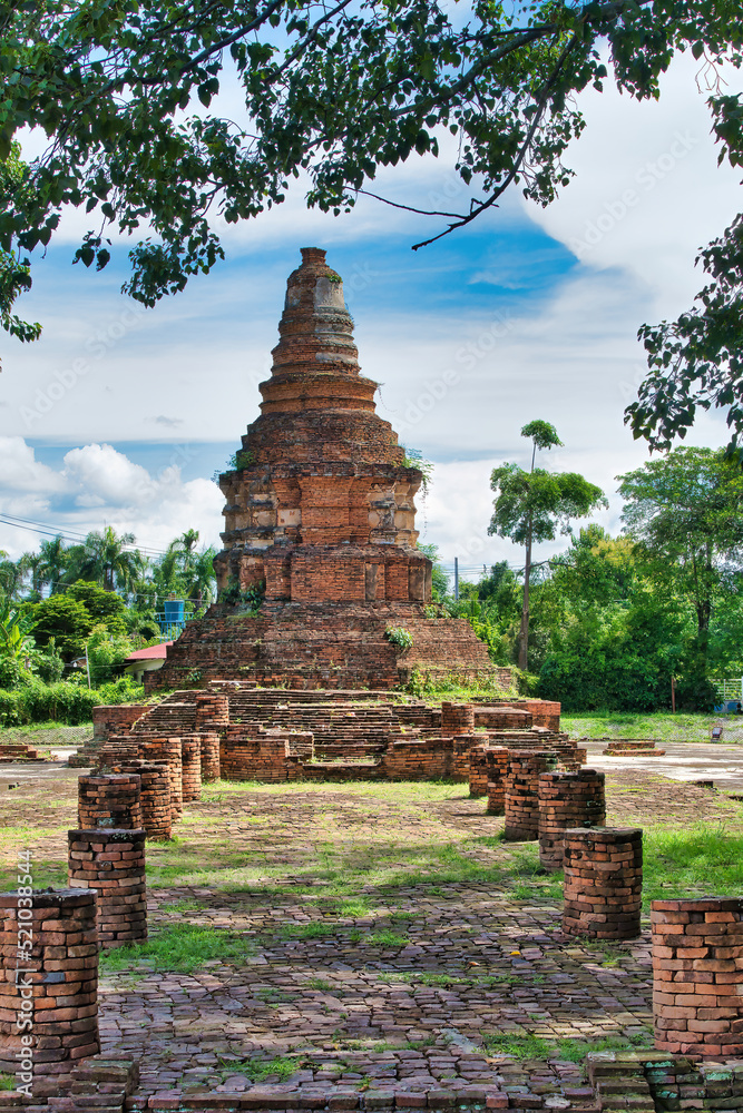 Chedi of the Wat I Khang, with the brick remains of the former temple, in Wiang Kum Kam archaeological site, Chiang Mai, Thailand
