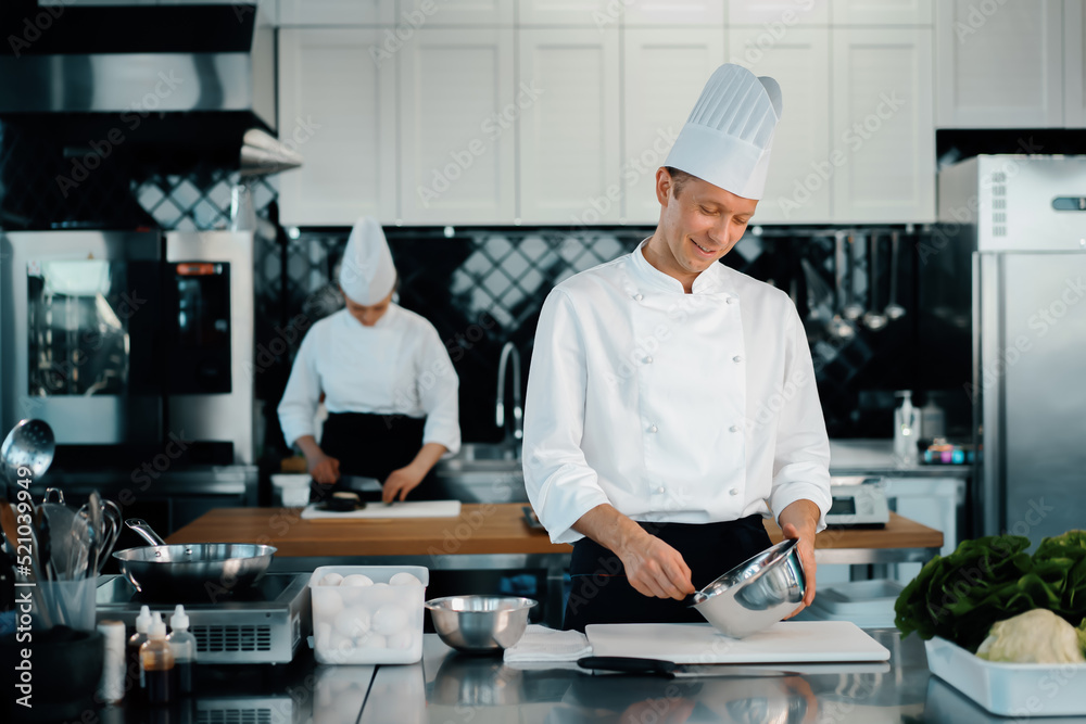 Professional restaurant kitchen: chefs prepare a delicious dish