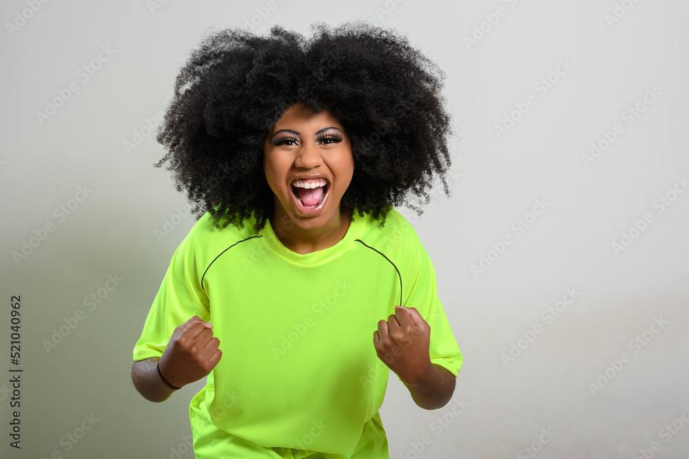 woman fan screams cheering for her team, celebrating, vibrant green uniform, young woman, gray background woman fan screams cheering for her team, celebrating, vibrant green uniform, young woman, gray background
