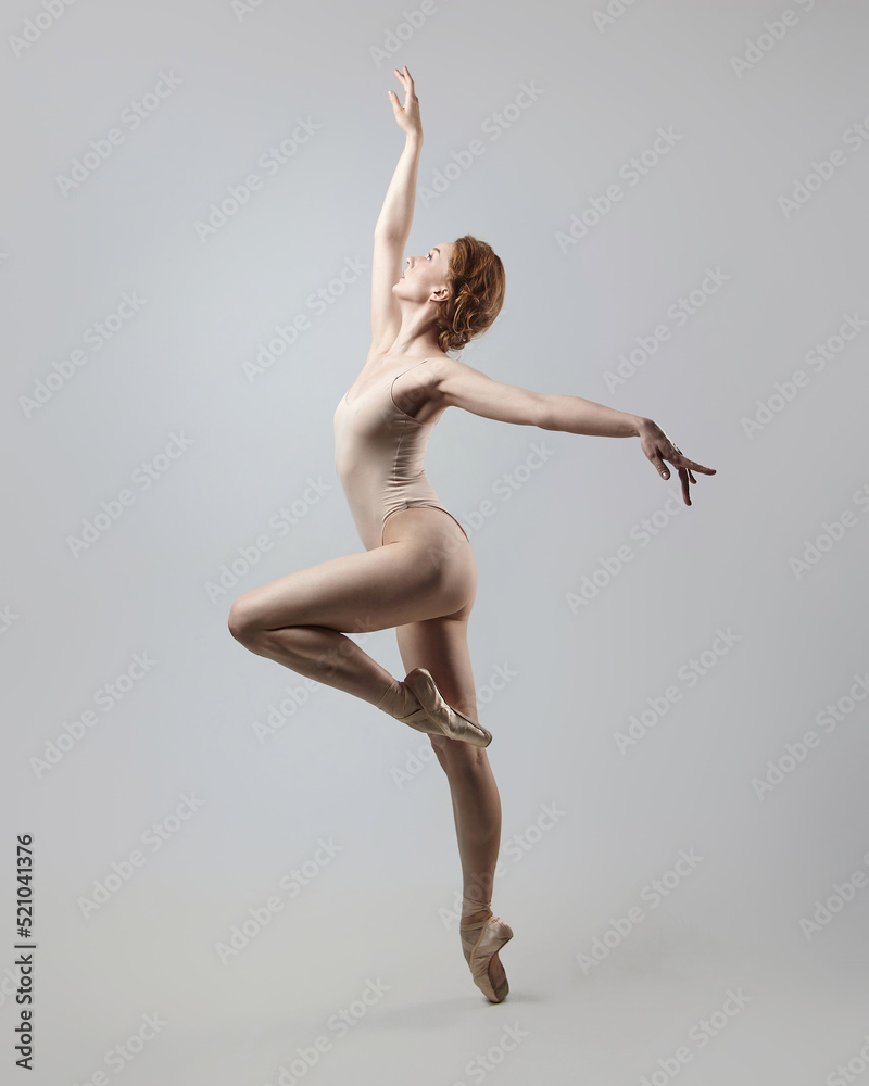 Fototapeta premium charming ballerina posing in the studio on a white background