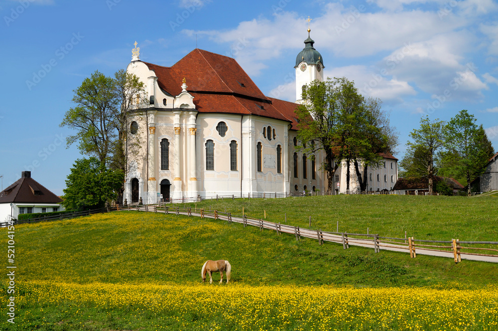 The Pilgrimage Church of Wies (German: Wieskirche) is an oval rococo church in the Bavarian Alps on a sunny day in May (Steingaden, Weilheim-Schongau district, Bavaria, Germany)