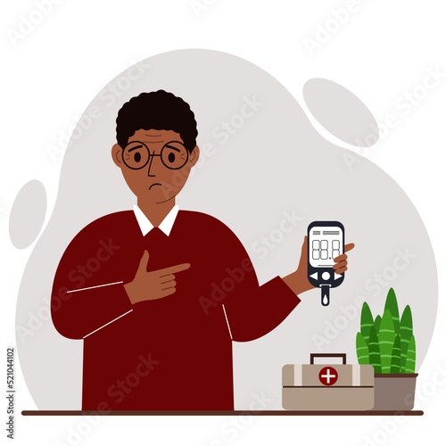 Sad man holds a glucometer in his hand. The concept of blood sugar control, diabetic.