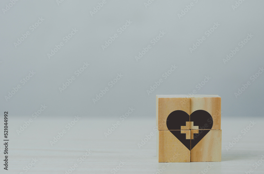Wooden cube with health insurance icon on table background. Wooden cube with health insurance icon on table background.