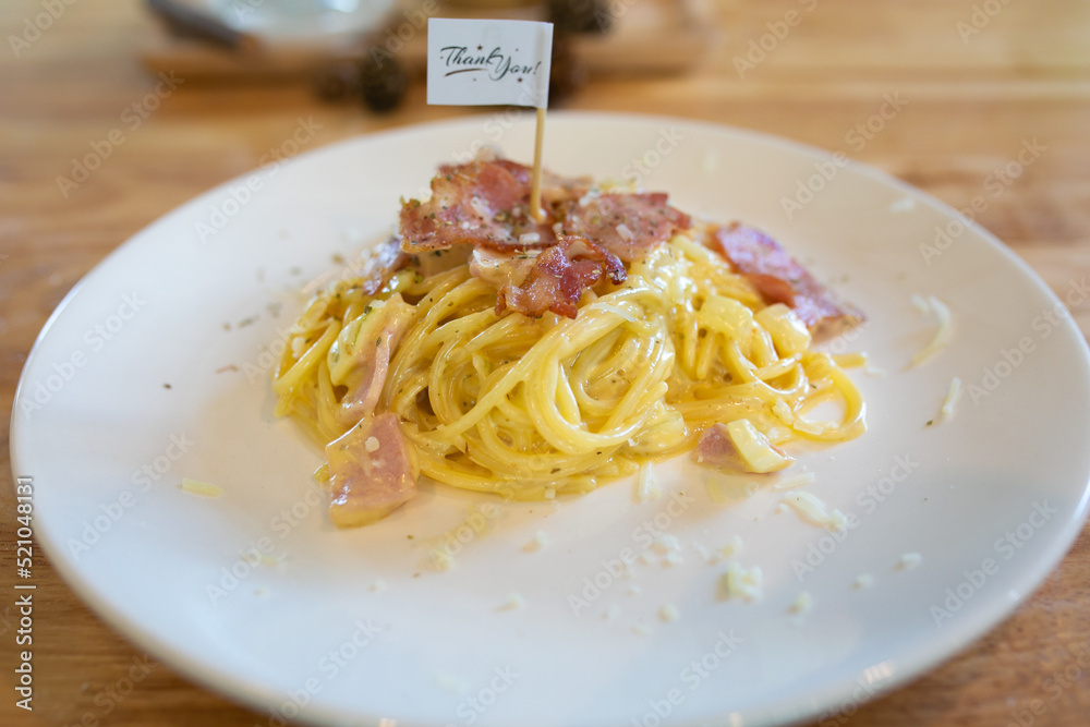Spaghetti Carbonara with bacon and parmesan on wooden table. Italian food. Spaghetti Carbonara with bacon and parmesan on wooden table. Italian food.