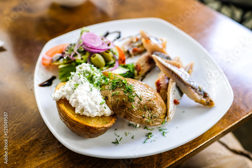 Boiled potatoes with cottage cheese and pickled herring. Defocused