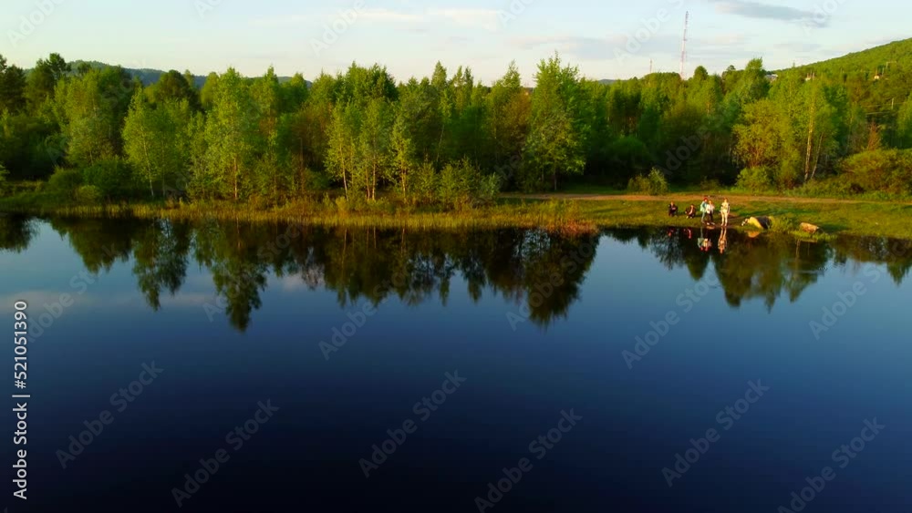 A lake on the outskirts of the village. There are green hills all around. The urban-type settlement of Kuldur in the Jewish Autonomous Region. The Russian Far East. A lake on the outskirts of the village. There are green hills all around. The urban-type settlement of Kuldur in the Jewish Autonomous Region. The Russian Far East.