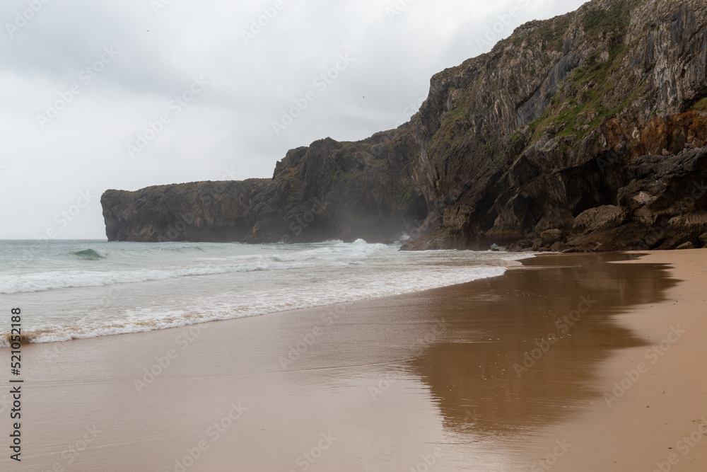 beach in the north of spain with a rough sea and beautiful cliffs