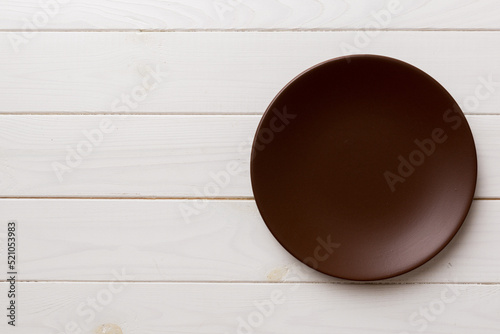 Top view of empty plate on wooden background. Empty space for your design