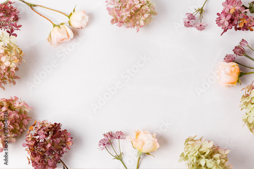 Autumn creative composition roses, hydrangea flowers on gray background. Fall, autumn background. Flat lay, top view, copy space