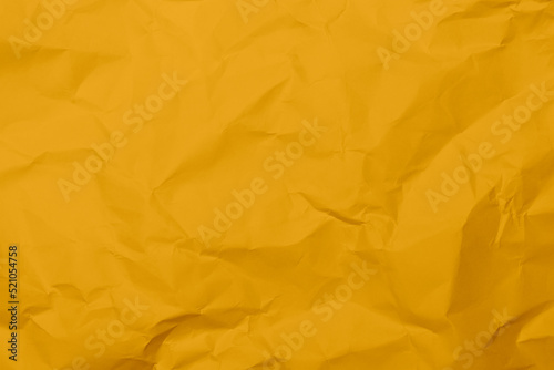 Closeup yellow crumpled paper texture background. Yellow wrinkled paper texture background. Yellow crease fabric texture background. Yellow wrinkled fabric texture background.