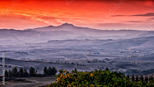Pitoresque region Tuscany, bloody sky during sunrise, Italy.