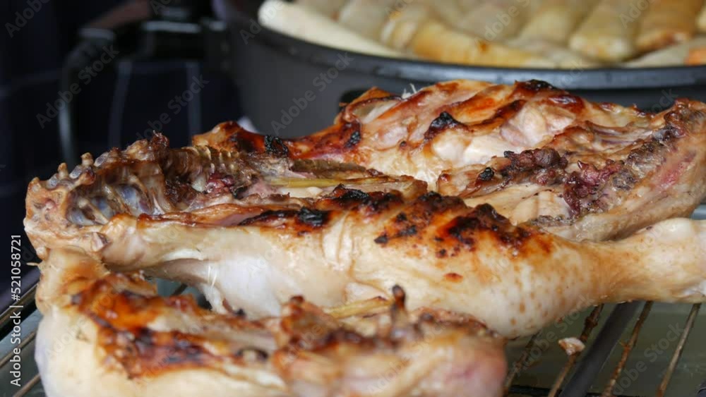 Grilled chicken legs are smeared with special soy sauce. Delicious greasy street food Grilled chicken legs are smeared with special soy sauce. Delicious greasy street food