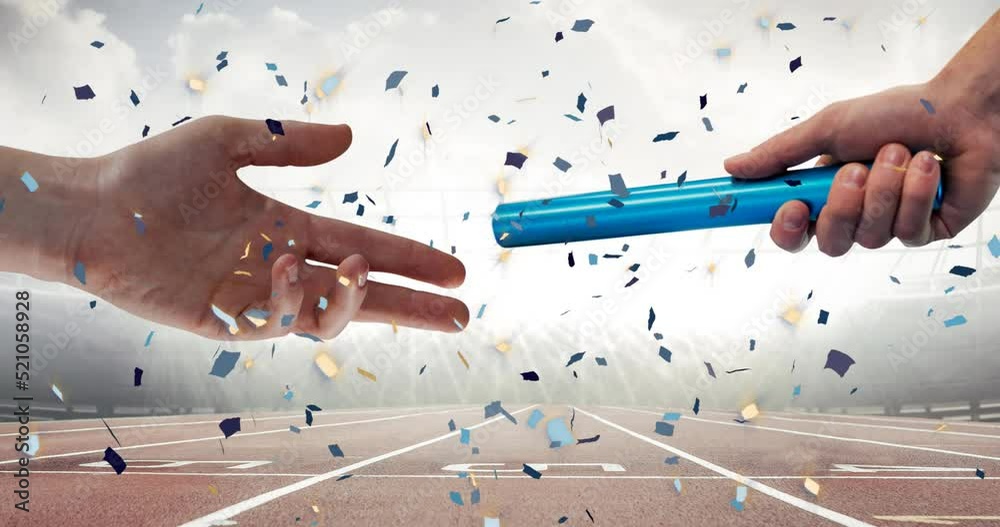 Confetti falling over close up of a hand passing a baton against sports field