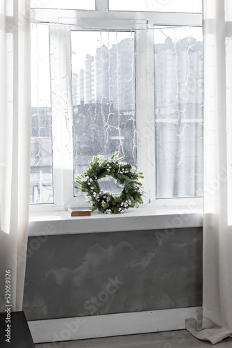 A Christmas wreath on the windowsill