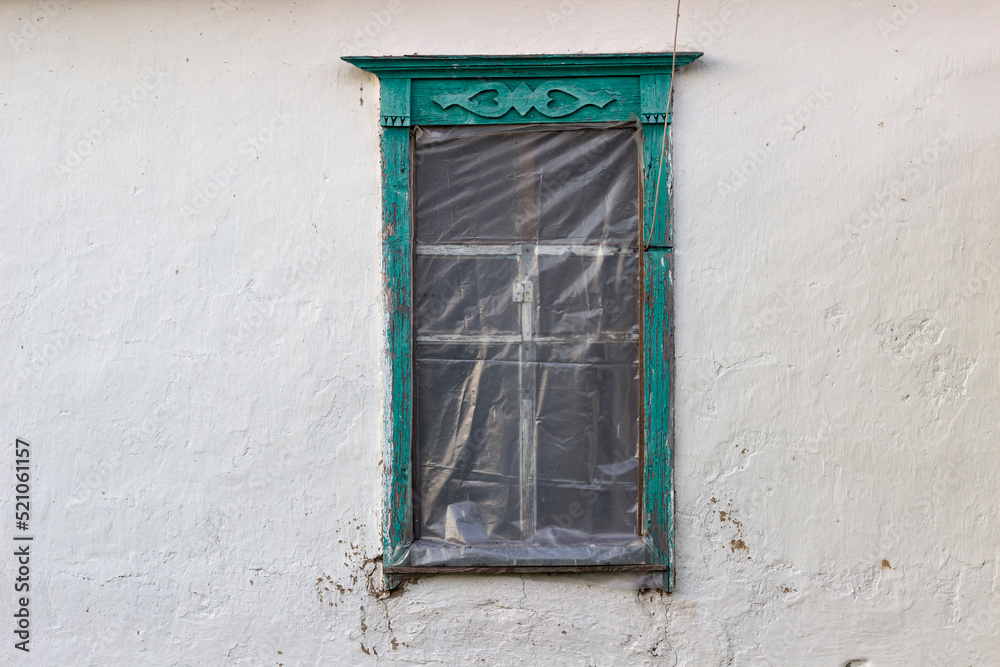 old wooden window on a clay wall