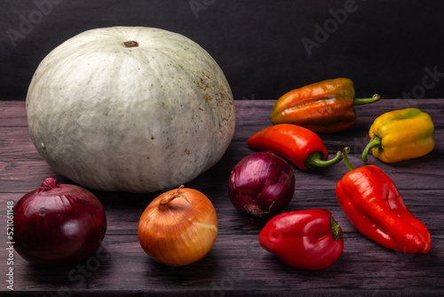 pumpkin  onions and bell peppers on a dark background  