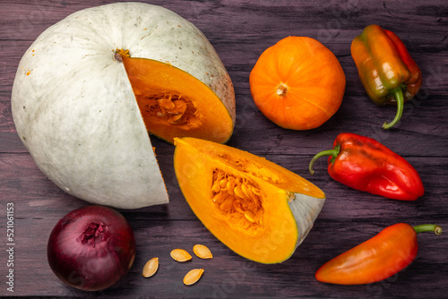 pumpkin, onions and bell peppers on a dark background  top view