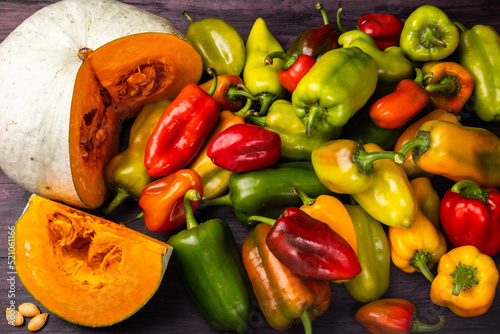 pumpkin, seeds and a lot of peppers on a table view from above