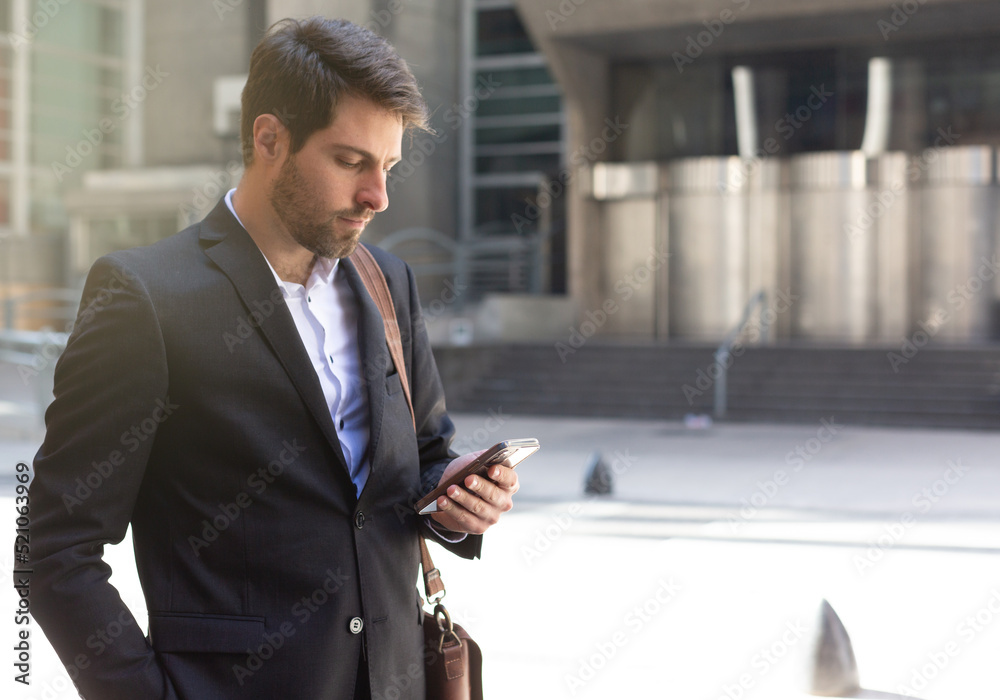 handsome young businessman talking on smartphone while walking on his way to his office. business, lifestyle, technology device and Social media network concept handsome young businessman talking on smartphone while walking on his way to his office. business, lifestyle, technology device and Social media network concept