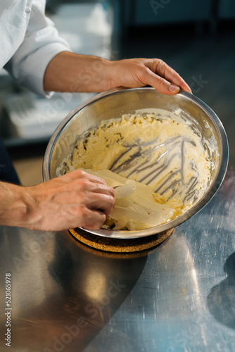 Close-up of a chef mixing milk mix for ice cream in a professional kitchen restaurant