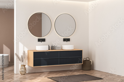 Bright bathroom interior with wooden cabinet, double sink, white bathtub, towel, carpet and window with sunlight. Sinks with mirrors on white wall, parquet floor. 3d rendering 
