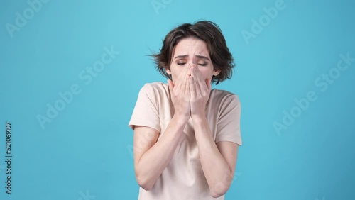 Lady wearing clothes out of weather feel cold isolated on blue color background